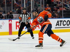 Edmonton Oilers' Evan Bouchard (75) fires a slapshot on Vancouver Canucks' Jaroslav Halak (41) during the third period of preseason NHL action at Rogers Place in Edmonton, on Thursday, Oct. 7, 2021.
