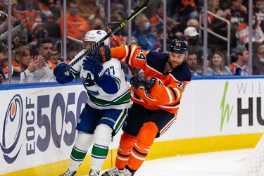 Edmonton Oilers' Zack Kassian (44) battles Vancouver Canucks' Brad Hunt (77) during the third period of preseason NHL action at Rogers Place in Edmonton, on Thursday, Oct. 7, 2021.