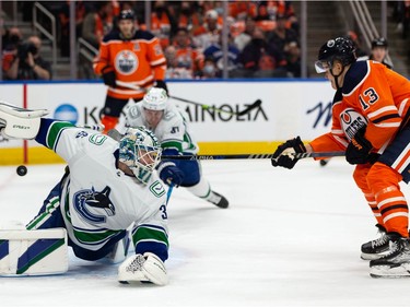 Edmonton Oilers' Jesse Puljujarvi (13) scores on Vancouver Canucks' goaltender Thatcher Demko (35) during first period NHL action at Rogers Place in Edmonton, on Wednesday, Oct. 13, 2021.