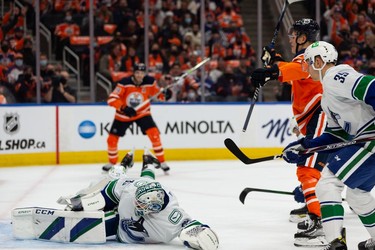 Edmonton Oilers' Jesse Puljujarvi (13) scores on Vancouver Canucks' goaltender Thatcher Demko (35) during first period NHL action at Rogers Place in Edmonton, on Wednesday, Oct. 13, 2021.