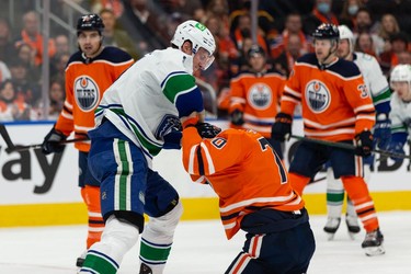 Edmonton Oilers' Colton Sceviour (70) fights Vancouver Canucks' Tyler Myers (57) during second period NHL action at Rogers Place in Edmonton, on Wednesday, Oct. 13, 2021.