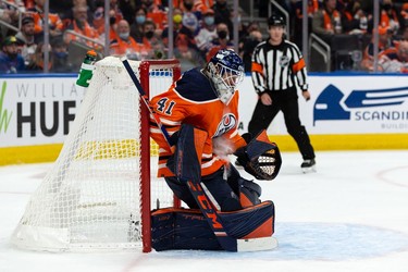 Edmonton Oilers' goaltender Mike Smith (41) makes a save on the Vancouver Canucks during second period NHL action at Rogers Place in Edmonton, on Wednesday, Oct. 13, 2021.