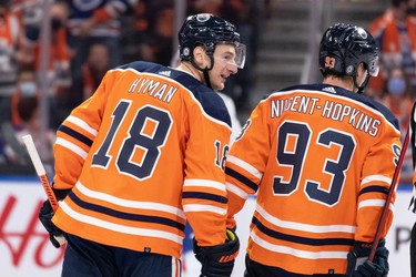 Edmonton Oilers' Zach Hyman (18) celebrates a goal with Ryan Nugent-Hopkins (93) on Vancouver Canucks' goaltender Thatcher Demko (35) during second period NHL action at Rogers Place in Edmonton, on Wednesday, Oct. 13, 2021.