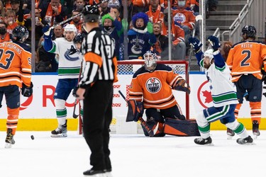Vancouver Canucks' Oliver Ekman-Larsson (23) scores a goal on Edmonton Oilers' goaltender Mike Smith (41) during third period NHL action at Rogers Place in Edmonton, on Wednesday, Oct. 13, 2021.