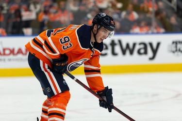 Edmonton Oilers' Ryan Nugent-Hopkins (93) faces off against the Vancouver Canucks during second period NHL action at Rogers Place in Edmonton, on Wednesday, Oct. 13, 2021.