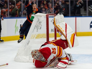Edmonton Oilers' Connor McDavid (97) scores a goal on Calgary Flames goaltender Jacob Markstrom (25) during first period NHL action at Rogers Place in Edmonton, on Saturday, Oct. 16, 2021.