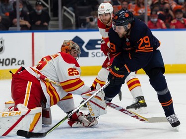 Edmonton Oilers' Leon Draisaitl (29) is stopped by Calgary Flames goaltender Jacob Markstrom (25) during first period NHL action at Rogers Place in Edmonton, on Saturday, Oct. 16, 2021.