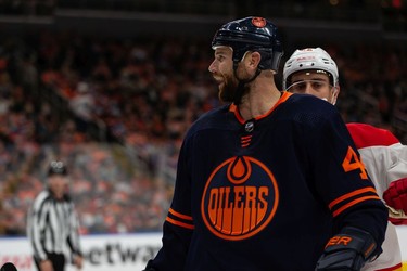 Edmonton Oilers' Zack Kassian (44) laughs at Calgary Flames Matthew Tkachuk (19) after a hit during second period NHL action at Rogers Place in Edmonton, on Saturday, Oct. 16, 2021.