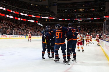 Edmonton Oilers' Jesse Puljujarvi (13) celebrates a goal with teammates on Calgary Flames goaltender Jacob Markstrom (25) during third period NHL action at Rogers Place in Edmonton, on Saturday, Oct. 16, 2021.