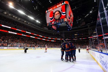 Edmonton Oilers' Jesse Puljujarvi (13) celebrates a goal with teammates on Calgary Flames goaltender Jacob Markstrom (25) during third period NHL action at Rogers Place in Edmonton, on Saturday, Oct. 16, 2021.