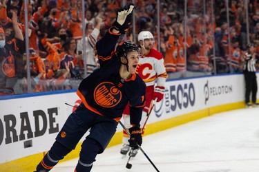 Edmonton Oilers' Jesse Puljujarvi (13) celebrates a goal on  Calgary Flames goaltender Jacob Markstrom (25) during third period NHL action at Rogers Place in Edmonton, on Saturday, Oct. 16, 2021.