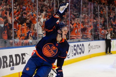 Edmonton Oilers' Jesse Puljujarvi (13) celebrates a goal on  Calgary Flames goaltender Jacob Markstrom (25) during third period NHL action at Rogers Place in Edmonton, on Saturday, Oct. 16, 2021.