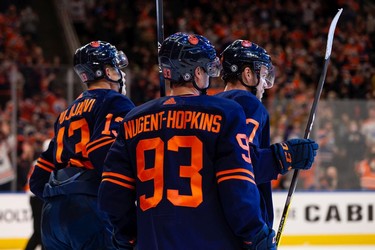 Edmonton Oilers' Connor McDavid (97) celebrates a goal on Philadelphia Flyers' goaltender Carter Hart (79) with teammates during first period NHL action at Rogers Place in Edmonton, on Wednesday, Oct. 27, 2021.