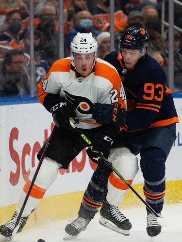Edmonton Oilers' Ryan Nugent-Hopkins (93) battles Philadelphia Flyers' Nick Seeler (24) during first period NHL action at Rogers Place in Edmonton, on Wednesday, Oct. 27, 2021.