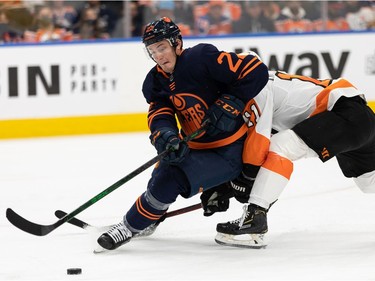 Edmonton Oilers' Tyson Barrie (22) downs Philadelphia Flyers' Travis Konecny (11) during second period NHL action at Rogers Place in Edmonton, on Wednesday, Oct. 27, 2021.