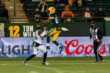 Edmonton Elks' Derel Walker (87) misses a catch as  Hamilton Tiger-Cats' Cariel Brooks (26) reaches for a block during first half CFL action at Commonwealth Stadium in Edmonton, on Friday, Oct. 29, 2021.