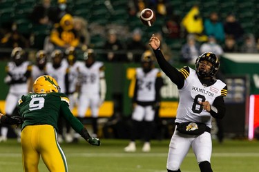 Hamilton Tiger-Cats' quarterback Jeremiah Masoli (8) throws the ball past Edmonton Elks' Mathieu Betts (9) during first half CFL action at Commonwealth Stadium in Edmonton, on Friday, Oct. 29, 2021.