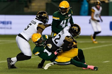 Edmonton Elks' Derrick Moncrief (10) tackles Hamilton Tiger-Cats' Tim White (12) during first half CFL action at Commonwealth Stadium in Edmonton, on Friday, Oct. 29, 2021.