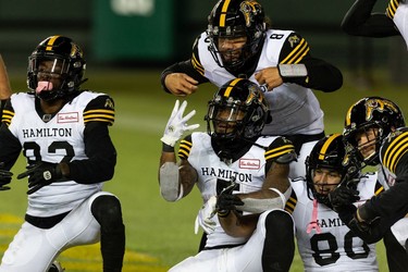 Hamilton Tiger-Cats' Don Jackson (5) celebrates a touchdown with teammates on the Edmonton Elks during second half CFL action at Commonwealth Stadium in Edmonton, on Friday, Oct. 29, 2021.