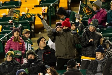 Edmonton Elks fans dance in the stands as the team plays the Hamilton Tiger-Cats during second half CFL action at Commonwealth Stadium in Edmonton, on Friday, Oct. 29, 2021.