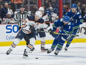 Vancouver Canucks forward J.T. Miller (9) defends against Edmonton Oilers forward Connor McDavid (97) in the first period at Rogers Arena.