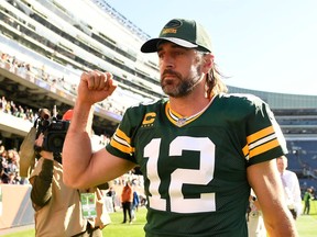 Aaron Rodgers #12 of the Green Bay Packers celebrates after the Packers defeated the Chicago Bears 24-14 at Soldier Field on October 17, 2021 in Chicago, Illinois.