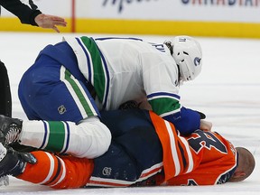 Edmonton Oilers forward Zack Kassian (44) is injured during a fight with Vancouver Canucks forward Zack MacEwen (71) at Rogers Place on Thursday, Oct. 7, 2021.