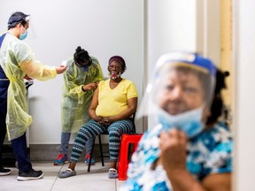 Doctor Meera Jayarajan and nurse Kevin Sagun from Humber River Hospital administer the Moderna COVID-19 vaccine to residents at a Toronto Community Housing seniors building in the northwest end of Toronto, March 25, 2021.