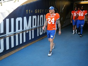 Winnipeg Blue Bombers fullback Mike Miller leads players down the tunnel wearing orange warmup jerseys both they and the Edmonton Elks will be wearing Friday in recognition of Orange Shirt Day during a press conference at IG Field on Tues., Oct. 5, 2021.