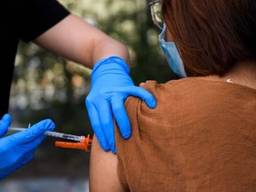 In this file photo a 15-year-old receives a first dose of the Pfizer Covid-19 vaccine at a mobile vaccination clinic at the Weingart East Los Angeles YMCA on May 14, 2021 in Los Angeles, Calif.