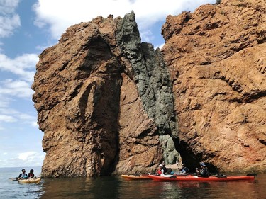 Kayakers explore the rugged coastline along the Bay of Fundy in Nova Scotia. In July 2020, the area was designated as the Cliffs of Fundy UNESCO Geopark for its geological significance. Pamela Roth