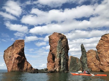 Kayakers explore the rugged coastline along the Bay of Fundy in Nova Scotia. In July 2020, the area was designated as the Cliffs of Fundy UNESCO Geopark for its geological significance. Pamela Roth