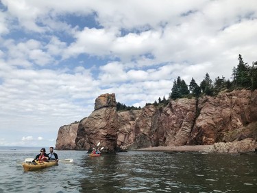 Kayakers explore the rugged coastline along the Bay of Fundy in Nova Scotia. Pamela Roth