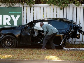 A man surveys the scene of a two-car crash along 153 Avenue east of 66 Street in Edmonton on Oct. 24, 2021. One person was transported to hospital in stable condition.