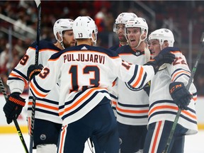 Oct 21, 2021; Glendale, Arizona, USA; Edmonton Oilers center Connor McDavid (97) celebrates his goal against the Arizona Coyotes with teammates on the ice during the second period at Gila River Arena. Mandatory Credit: Mark J. Rebilas-USA TODAY Sports