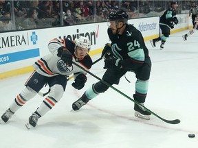 Edmonton Oilers' James Hamblin (57) skates past Seattle Kraken's Jamie Oleksiak (2) in the first period of a preseason NHL hockey Friday, Oct. 1, 2021, in Everett, Wash.