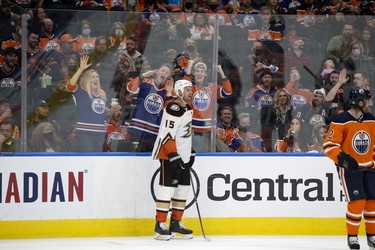The Edmonton Oilers fans celebrate as the Anaheim Ducks' Ryan Getzlaf (15) draws a penalty during second period NHL action at Rogers Place, in Edmonton Tuesday Oct. 19, 2021.