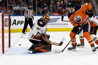 The Edmonton Oilers' Jesse Puljujarvi (13) looks on as Zack Kassian's (44) shot gets past battles the Anaheim Ducks' goalie Anthony Stolarz (41) during third period NHL action at Rogers Place, in Edmonton Tuesday Oct. 19, 2021.