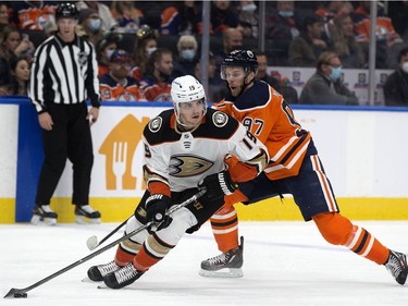The Edmonton Oilers' Connor McDavid (C) (97) chases battles the Anaheim Ducks' Troy Terry (19) during first period NHL action at Rogers Place, in Edmonton Tuesday Oct. 19, 2021.