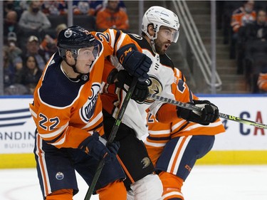 The Edmonton Oilers' Tyson Barrie (22) battles the Anaheim Ducks' Adam Henrique (14) during second period NHL action at Rogers Place, in Edmonton Tuesday Oct. 19, 2021.