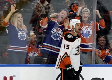 The Edmonton Oilers fans celebrate as the Anaheim Ducks' Ryan Getzlaf (15) draws a penalty during second period NHL action at Rogers Place, in Edmonton Tuesday Oct. 19, 2021.