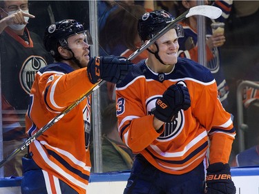 The Edmonton Oilers' Connor McDavid (C) (97) and Jesse Puljujarvi (13) celebrate McDavid's first period goal against the Anaheim Ducks during NHL action at Rogers Place, in Edmonton Tuesday Oct. 19, 2021.