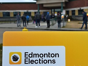 Voters lineup at the polling station in the Sspomitapi riding (formerly Ward 12) at Father Michael Troy School in Edmonton on Monday, Oct. 18, 2021.