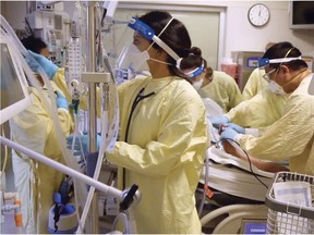 Teams in a crowded Calgary intensive care unit tend to a COVID-19 patient on a ventilator.