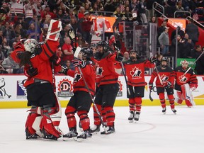 Shannon Szabados (1) of Canada celebrates a 2-0 win over of the United States with her teammates at Little Caesars Arena in Detroit on Feb. 17, 2019.