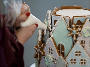 Julie Steele with Caron Transportation Systems works on her team's gingerbread house during the Christmas Bureau of Edmonton's 79th campaign kickoff at Rogers Place in Edmonton, on Monday, Nov. 25, 2019.