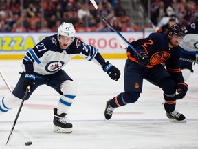 Nikolaj Ehlers #27 of the Winnipeg Jets skates against Duncan Keith #2 of the Edmonton Oilers during the third period at Rogers Place on November 18, 2021.
