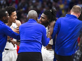 Head coach Dwane Casey of the Detroit Pistons and Cade Cunningham #2 of the Detroit Pistons calm down Isaiah Stewart #28 of the Detroit Pistons after Stewart was struck by LeBron James #6 of the Los Angeles Lakers during the third quarter of the game at Little Caesars Arena on November 21, 2021 in Detroit.