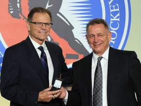 Member of the selection committee Mike Gartner (L) presents a Hall of Fame ring to Ken Holland at the Hockey Hall Of Fame on November 12, 2021 in Toronto.