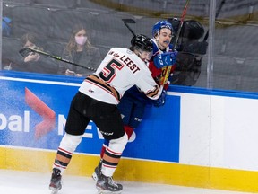 Edmonton Oil Kings’ Brendan Kuny (25) battles Calgary Hitmen’s Jackson van de Leest (5) during second period WHL action at Rogers Place in Edmonton, on Sunday, Nov. 21, 2021.